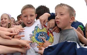 Kids pointing at their mad scientists lab coats mad science logo