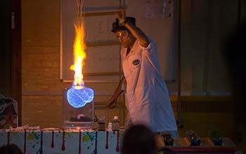 A Mad Scientist making fire in a glass jar